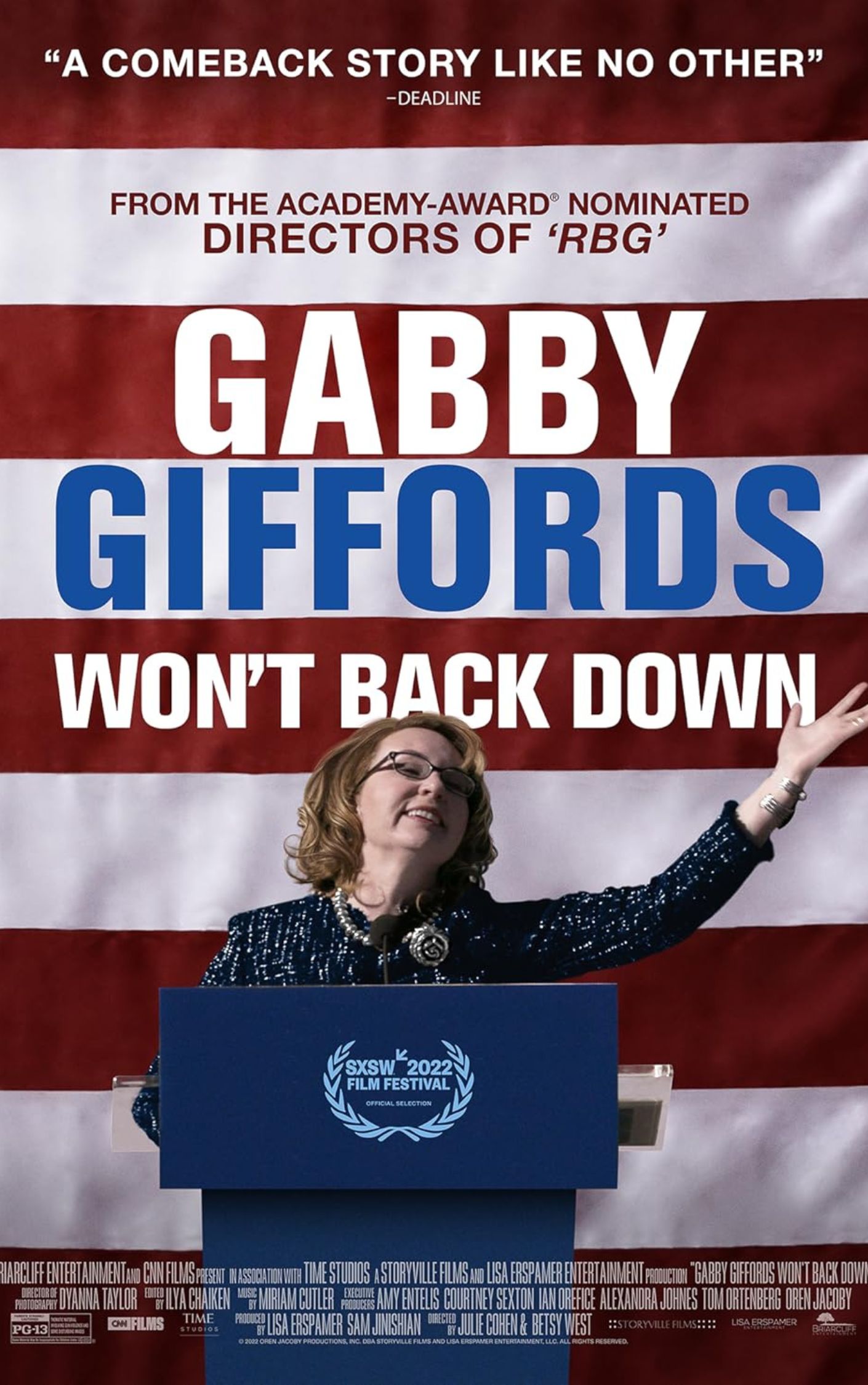 Poster for the documentary film “Gabby Giffords Won’t Back Down.” The poster shows former Congresswoman Gabby Giffords smiling and raising her arm at a podium in front of a large American flag. The text reads: “A comeback story like no other” — Deadline. From the Academy Award–nominated directors of ‘RBG.’ Gabby Giffords Won’t Back Down. SXSW 2022 Film Festival Official Selection.