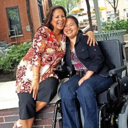 Paraprofessional Margaret Espinoza, left, with former student Becky Zang 10 years after 9/11, when the para wheeled and carried her student away from the World Trade Center. Credit: Bruce Gilbert