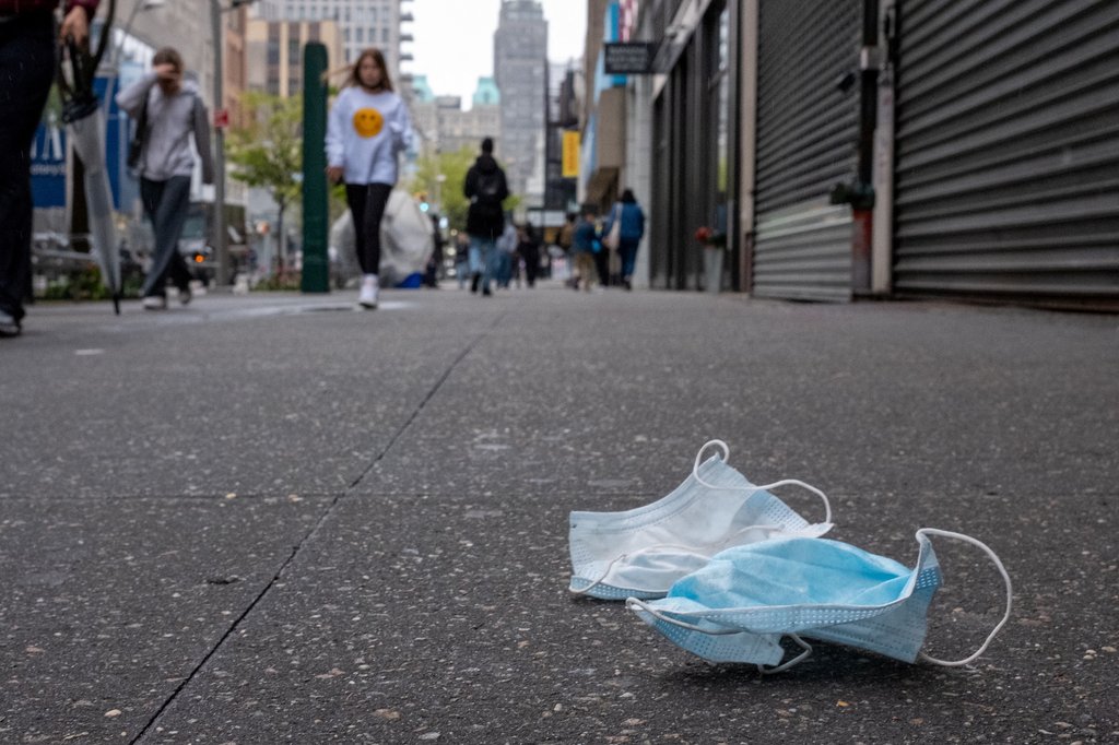 A pair of discarded face masks sit on the side walk in New York City, New York, U.S., May 2, 2022. REUTERS/David 'Dee' Delgado