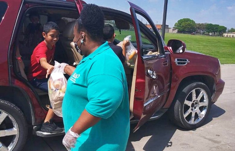 Yolanda Fisher manages her team of food service workers in Texas