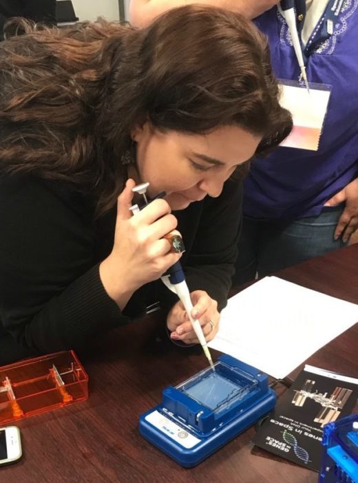 space science educator Tara Oakes adding a DNA sample to gel for sequencing during SEEC in Houston, Texas