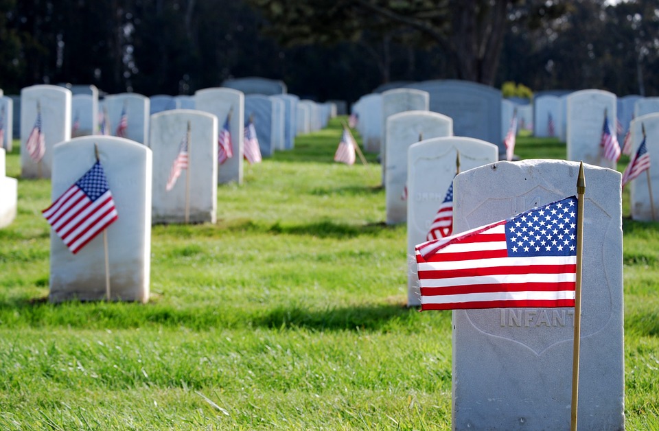 Flags in front of military graves at a national cemetery on Memorial Day